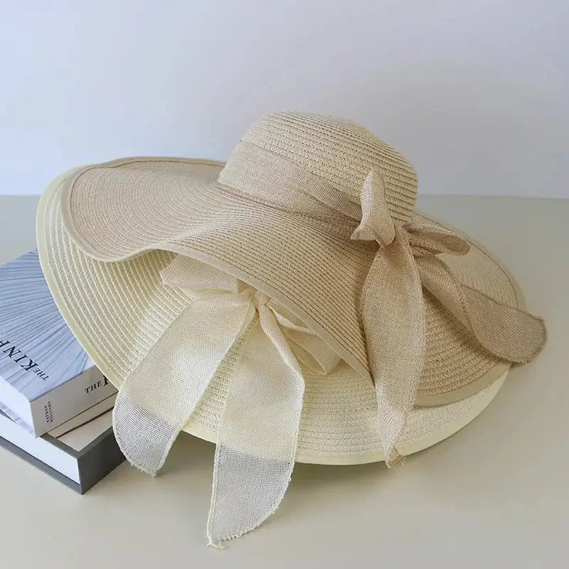 Stylish Summer Women Straw Hat Bowknot Wide Brim Floppy Panama Hats for beach outings by FAITOLAGIC, foldable sun cap.
